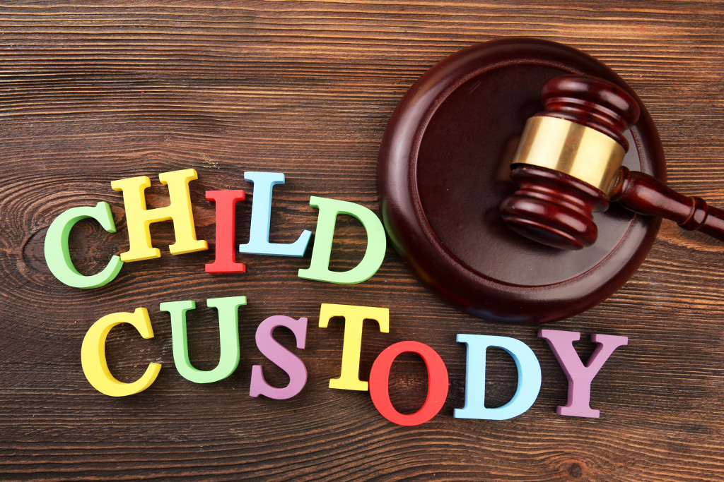 Colorful letters spelling the words CHILD CUSTODY with a wooden gavel beside it